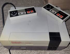 Nintendo NES console for sale with 2 controllers and cables, USD 80